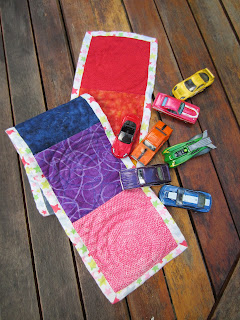 quilted rainbow table runner with matching toy cars