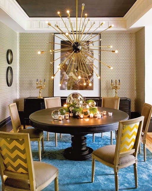 dining room with large gold modern sputnik chandelier