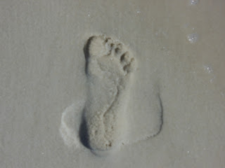 footprint in sand moving forward