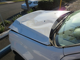 Dramatic hood damage before repairs at Almost Everything Auto Body