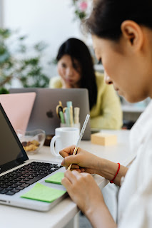 Image showing a fully focused woman typing  in her resume