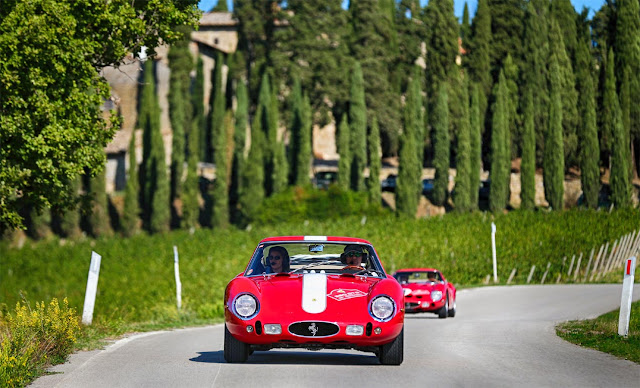 Red ferrrari 250 GTOs on grey road, green trees in the background, Ferrari GTO Cavalcade