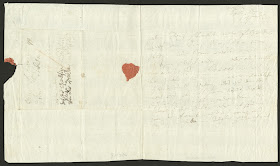 A handwritten letter with the remains of a red wax seal.