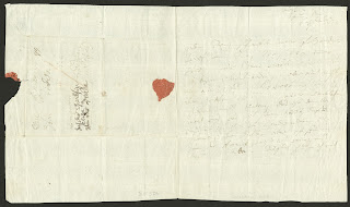 A handwritten letter with the remains of a red wax seal.