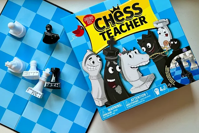 Chess Teacher box, board and pieces showing the moves and names on
