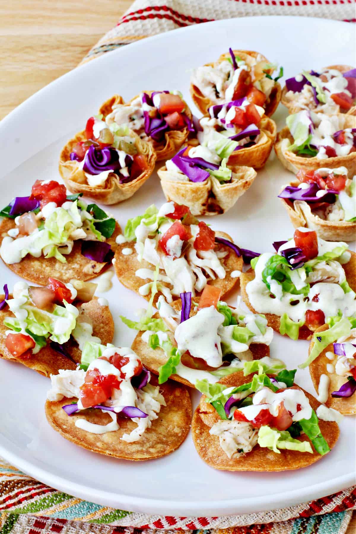 Mini Chicken Tostada Appetizers on a white platter.