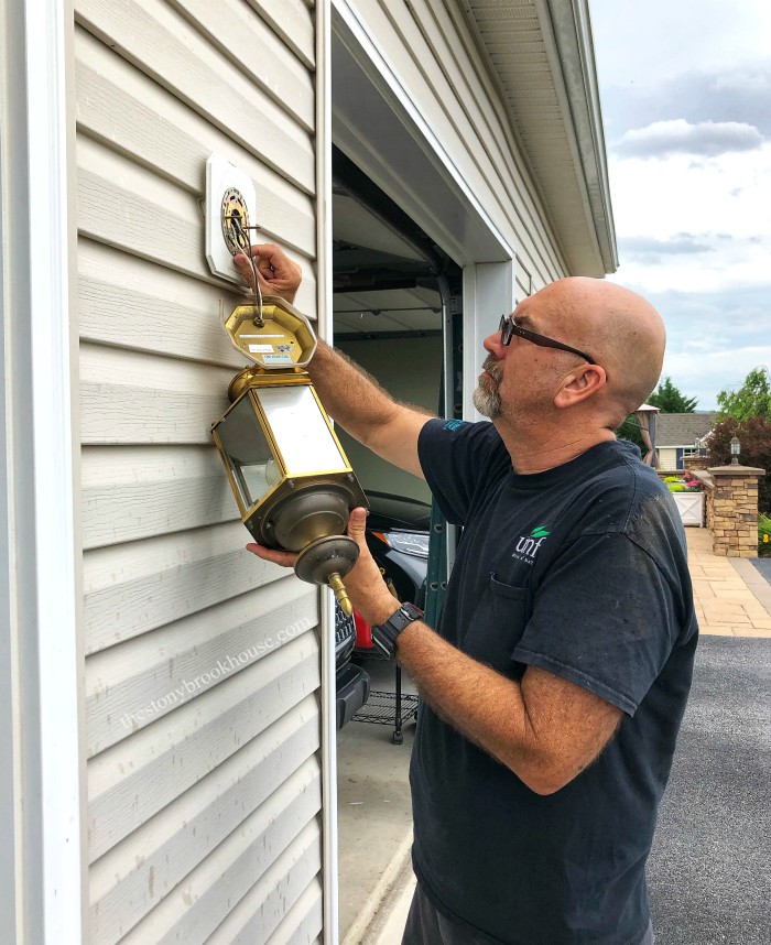 Hubby taking off outdoor light fixture