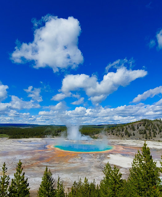 Steam rising from a beautiful, colorful hot spring