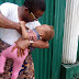 FUNNY: Nigerian man tries breastfeeding his baby in the absent of the wife - see photos