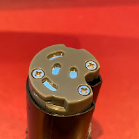 The terminals of the lightsaber battery compartment