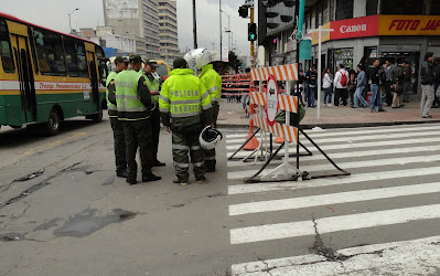 Efficient use of resources - a group of Bogotá's Transport Police manning a junction that already has a barrier erected. It gets them out of the office anyway