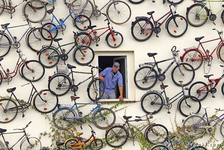 A funny man expose the 120 bicycles at his walls