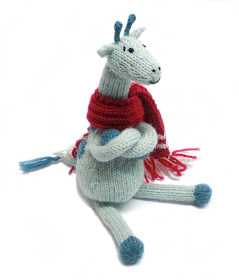 turquoise and teal knitted and crocheted giraffe with red and white scarf by Morrgan