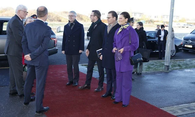 Crown Princess Victoria wore a wool and cashmere coat by Toteme. She wore a purple outfit, coat and pants, and a red dress