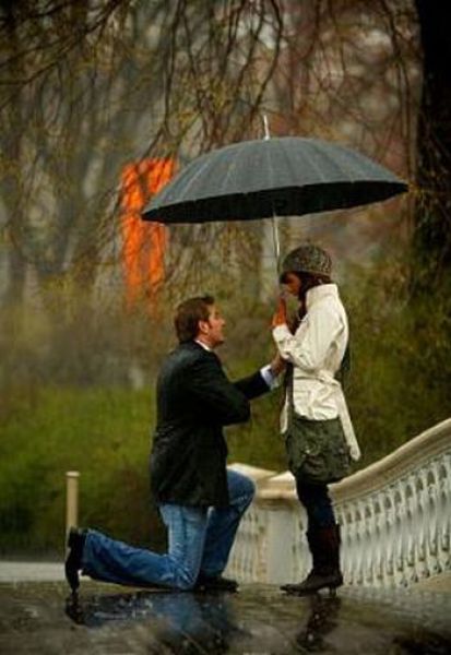 romantic couple kissing in rain. romantic couple kissing in the