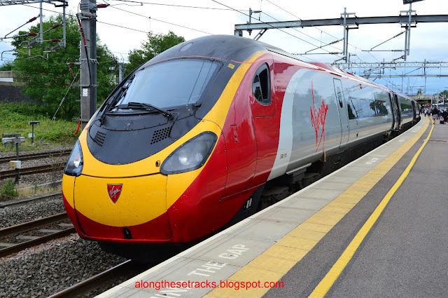 In colourful livery Virgin Pendolino Class 390010 EMU stands in Lichfield station