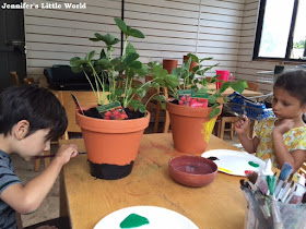 Painting strawberry planters at the garden centre