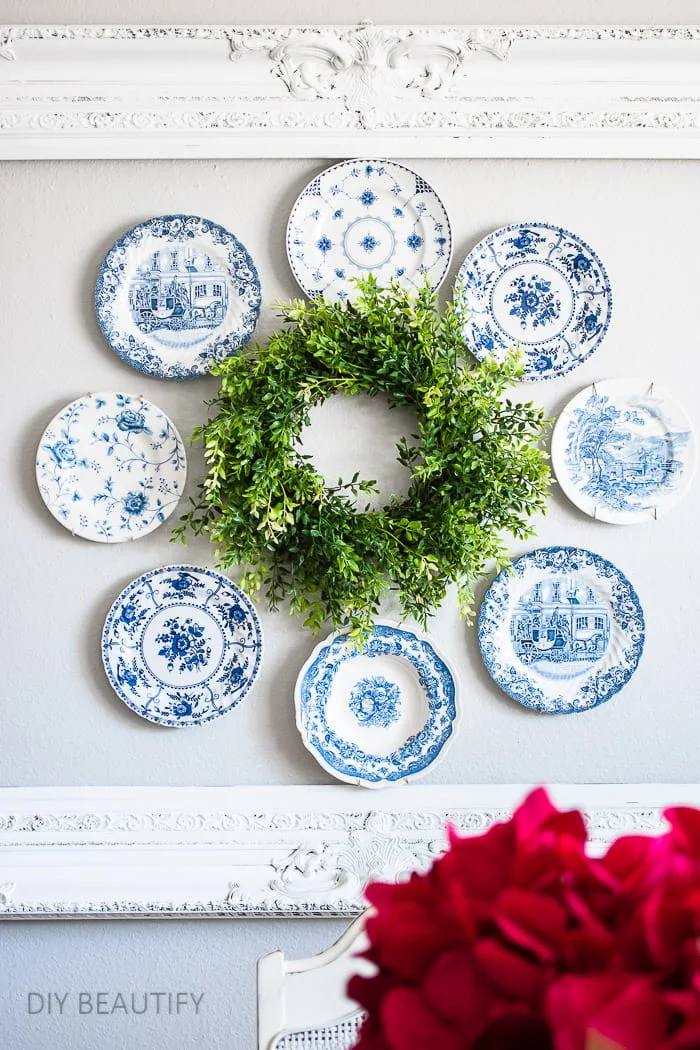 plate wreath hung inside open frame