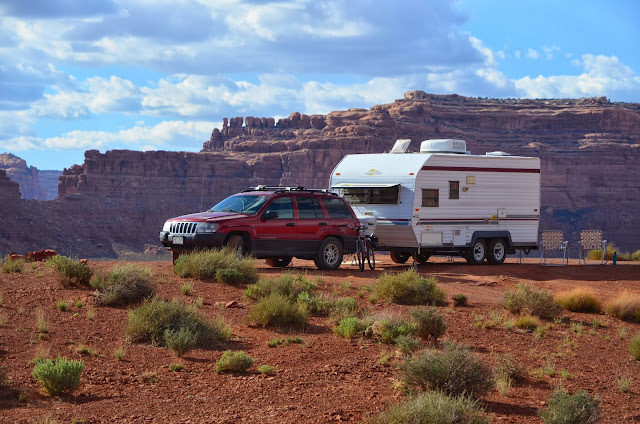 Red jeep, bike and travel trailer at camp in Southern Utah, Among the red rocks of Valley of the Gods