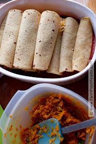 Recipe for a vegetarian enchilada casserole of corn tortillas stuffed with spicy sweet potatoes and onion