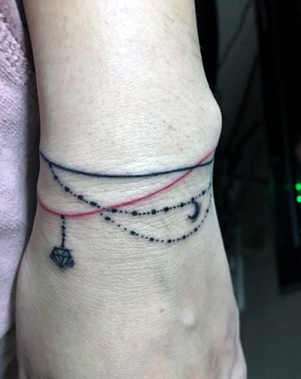 This wrist tattoo looks great with black work and red work ink bracelet tattoo designs for girls