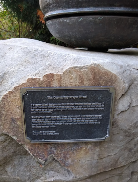 Plaque beneath the prayer wheel