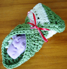 Small blanket tied around a stuffed animal for Operation Christmas Child shoebox packing.