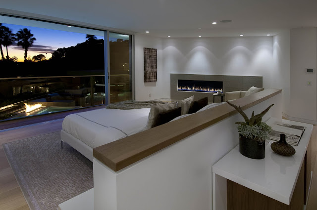 Picture of modern bedroom with fireplace and the view