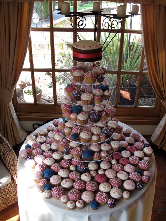 Hot pink and Navy cupcakes Here's a wedding tower we did for Anne in a hot