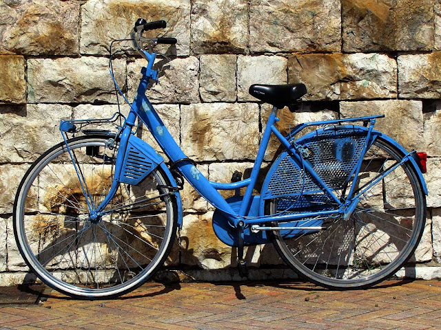 Blue womens bicycle at the Porto Mediceo, Livorno