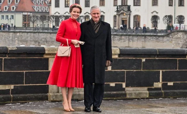 Queen Mathilde wore a red dress outfit, and fur collar coat in camel. Federal President Frank-Walter Steinmeier and Elke Büdenbender