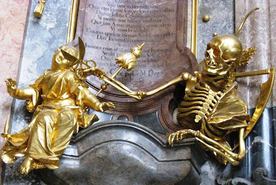 Gilded sculptures of skeleton cutting thread of life for unfortunate mortal