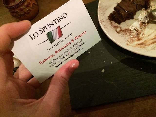 Business card for Lo Spuntino with empty plate in background