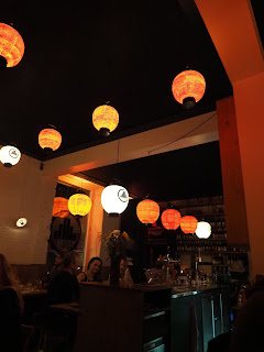 Lanterns hang around the ceiling and the edge of the bar