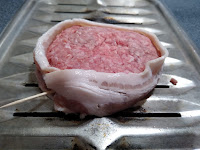 A hamburger wrapped in bacon