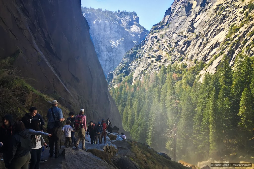 Many people on the Mist Trail. Trees below and Glacier Point in the distance.