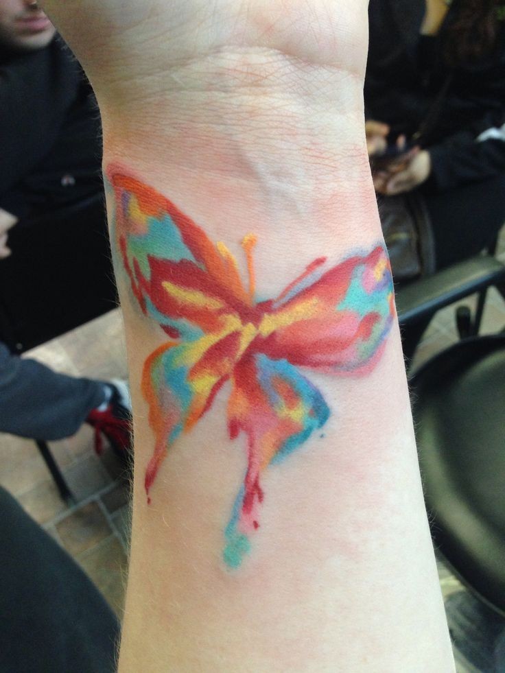 Colorful watercolor tattoos on arm for girls