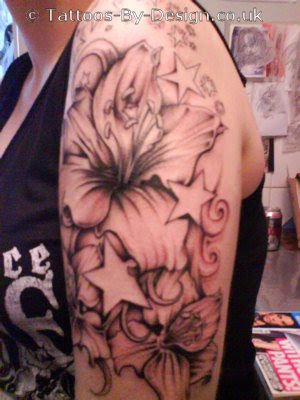 lauras flower at arm. Angel tattoo at side body