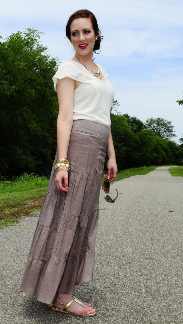 Tan tiered skirt, cream blouse, and gold accents