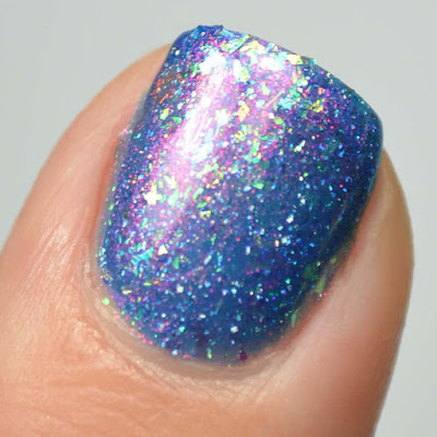 blue shimmer nail polish with flakies swatch