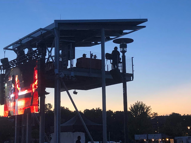 Sound crew working behind the big screen at RiverEdge Park.