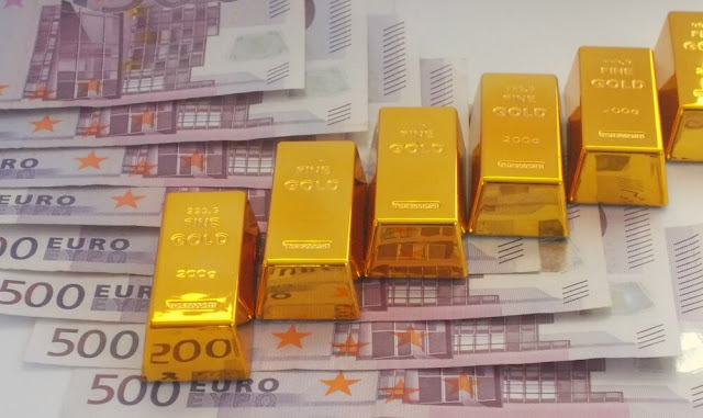 gold bars on top of euro notes