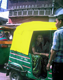 Smiling woman in rickshaw in Agra