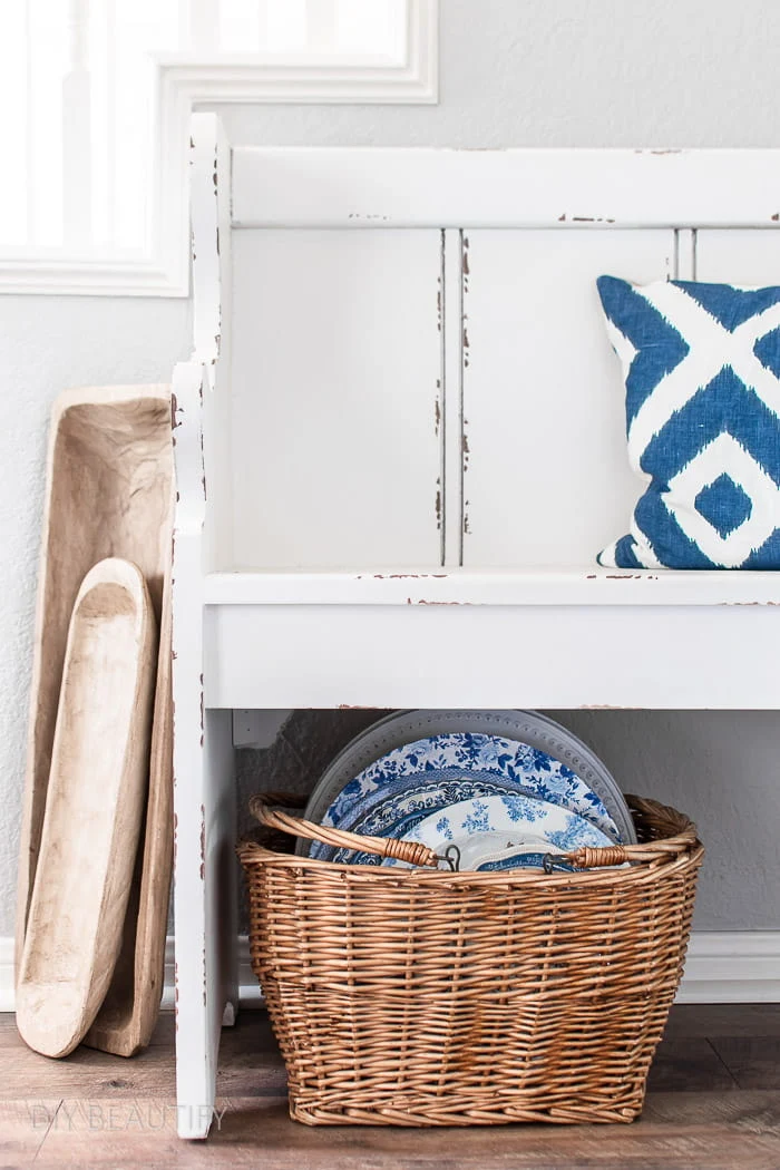 blue and white dishes in basket, white farmhouse pew, wood dough bowls