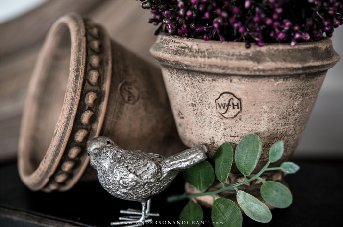 Silver bird and clay pots