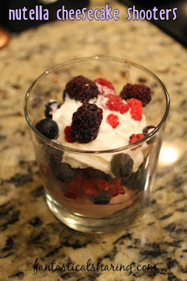 Nutella Cheesecake Shooters | The perfect light dessert with a fluffy cheesecake filling layered with berries and whipped cream on top of a graham crust #SundaySupper #nutella #recipe