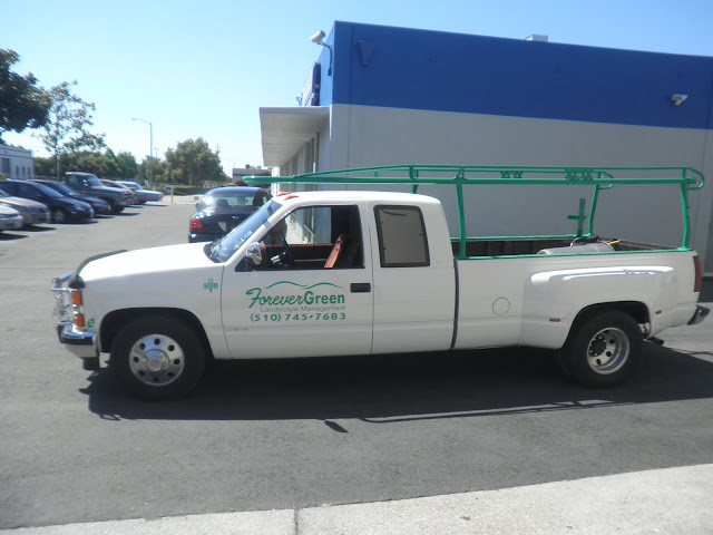 Commercial truck repainted with company colors and artwork at Almost Everything Auto Body