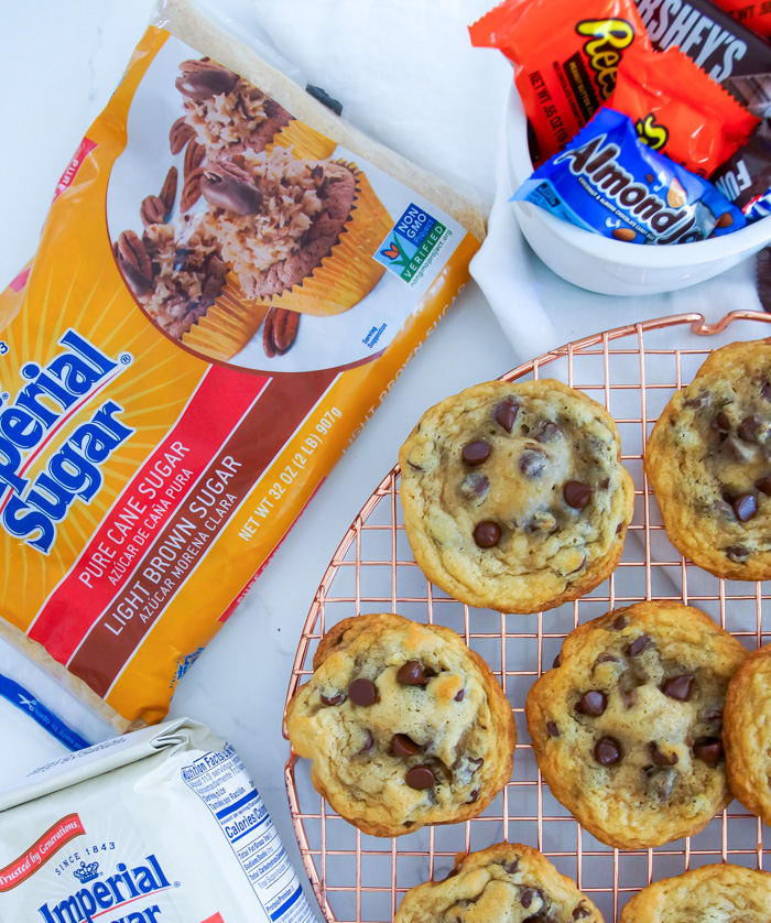 Chocolate Chip Candy Bar-Stuffed Cookies with bags of imperial sugar