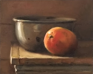 Oil painting of a mango beside an enamelware bowl on a bench top.
