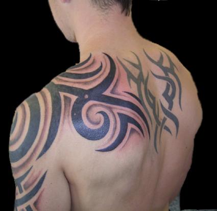 tattoos for men on back shoulder Man with an unique motive of tribbal